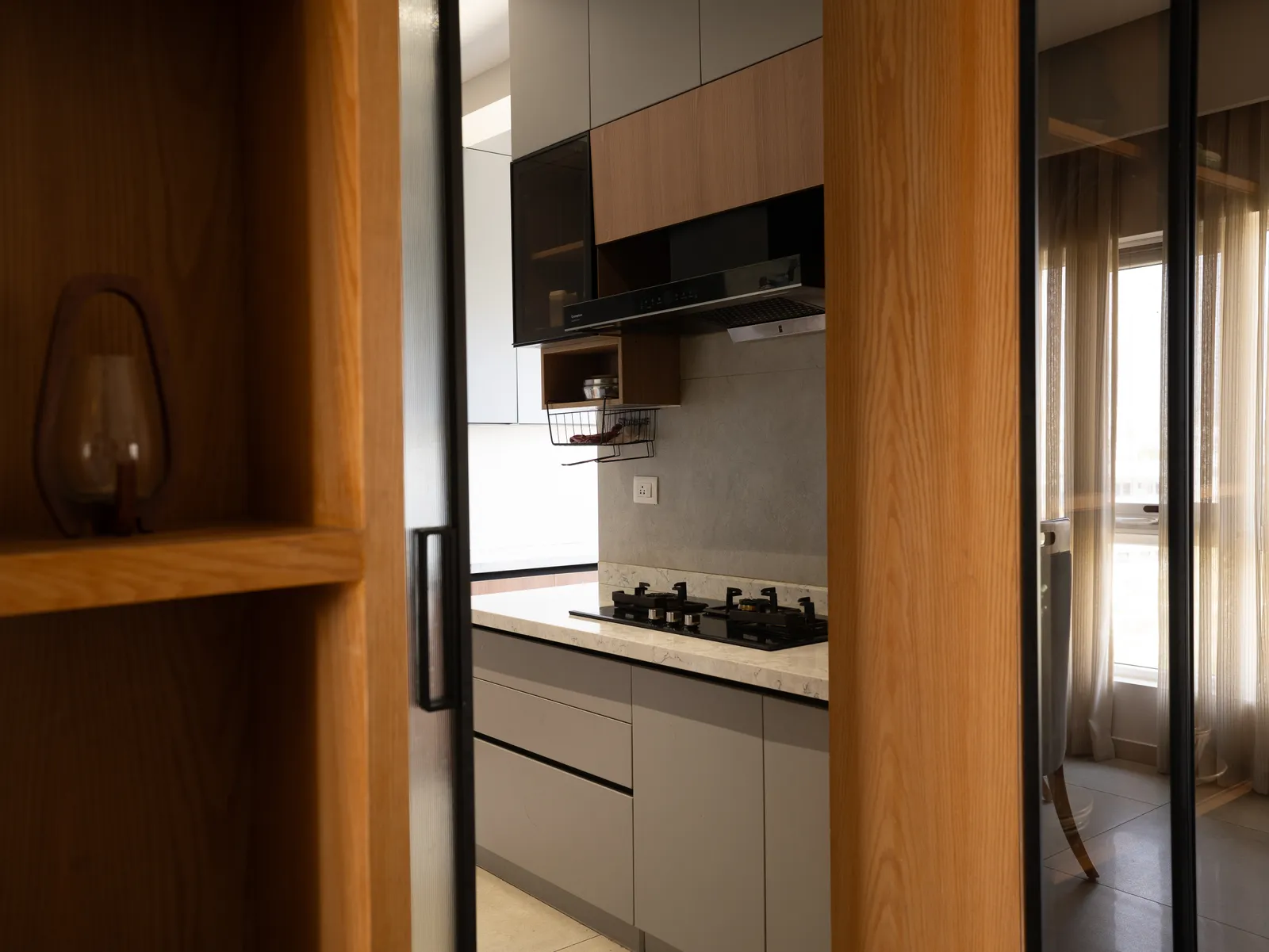 Oak-framed glass partition into the kitchen — Amlan's Residence